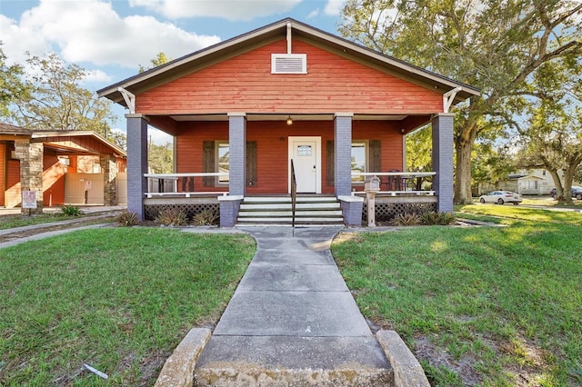 view of front facade with a porch and a front lawn