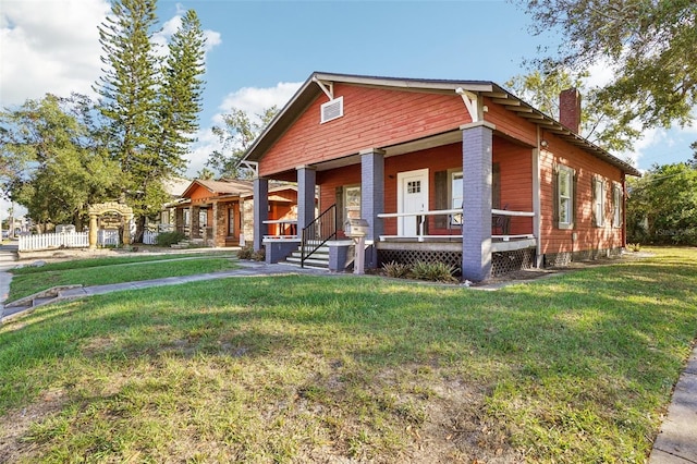 view of front of home featuring covered porch and a front yard