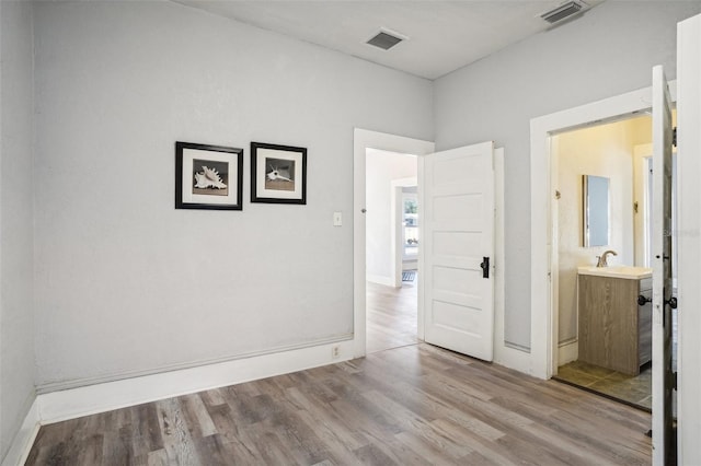 interior space with sink and light hardwood / wood-style floors