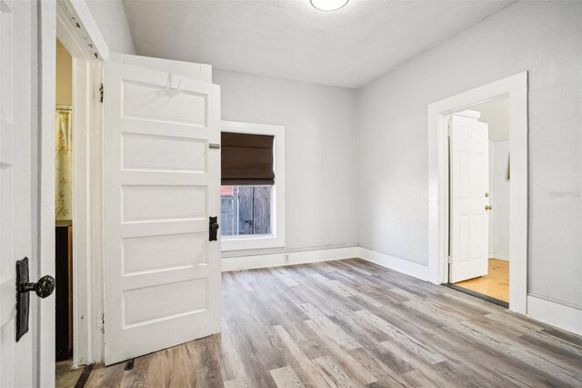 empty room with light hardwood / wood-style floors