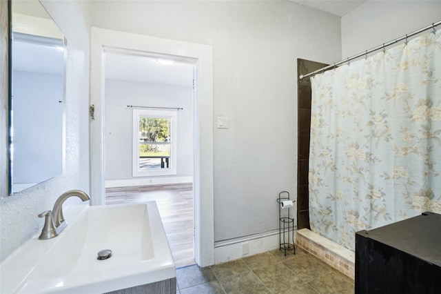 bathroom with tile patterned flooring, vanity, and walk in shower