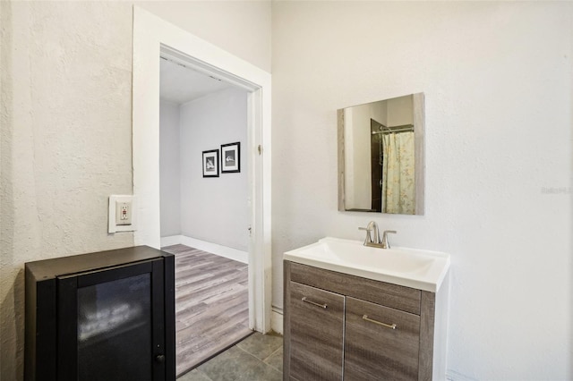 bathroom with hardwood / wood-style flooring and vanity