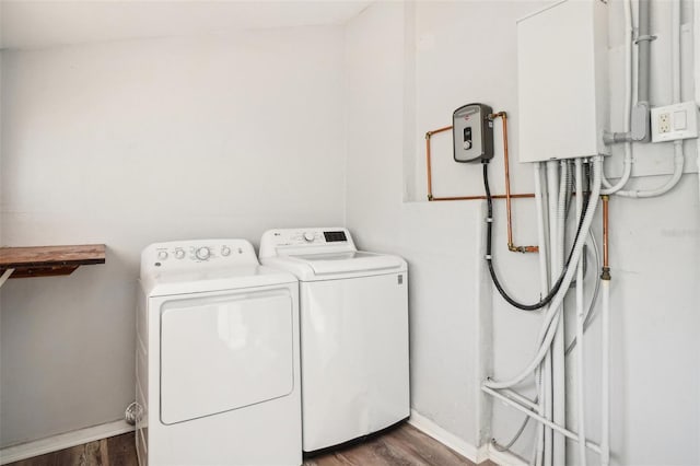 laundry area featuring dark hardwood / wood-style flooring and washer and dryer