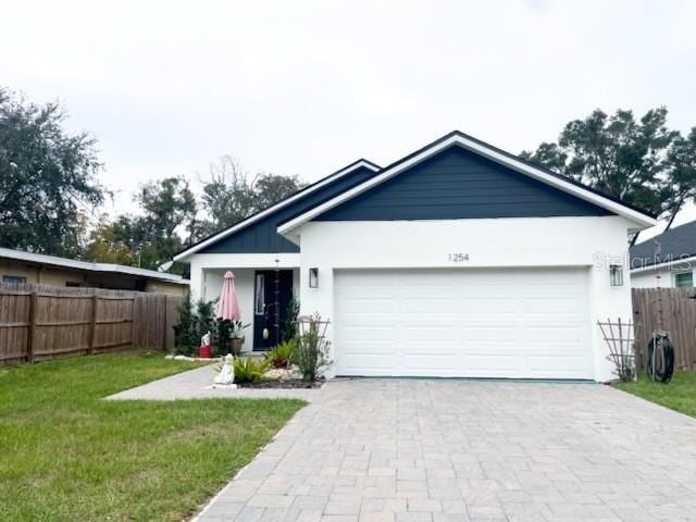 view of front of property with a garage and a front lawn