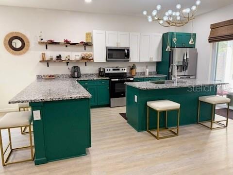 kitchen featuring a kitchen island, light wood-type flooring, stainless steel appliances, and a breakfast bar area