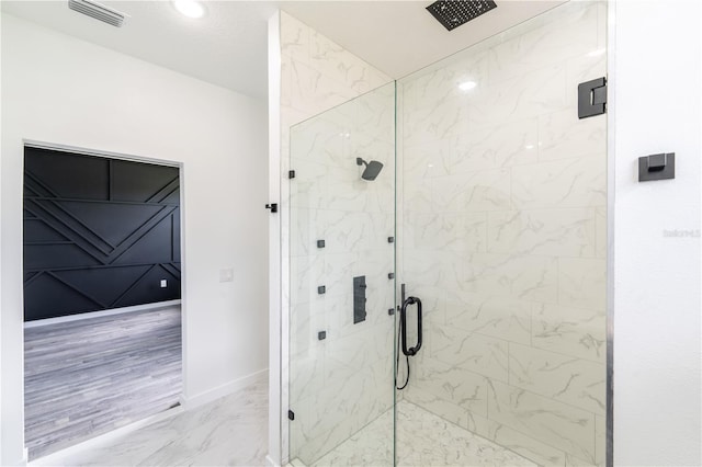 bathroom with an enclosed shower and wood-type flooring