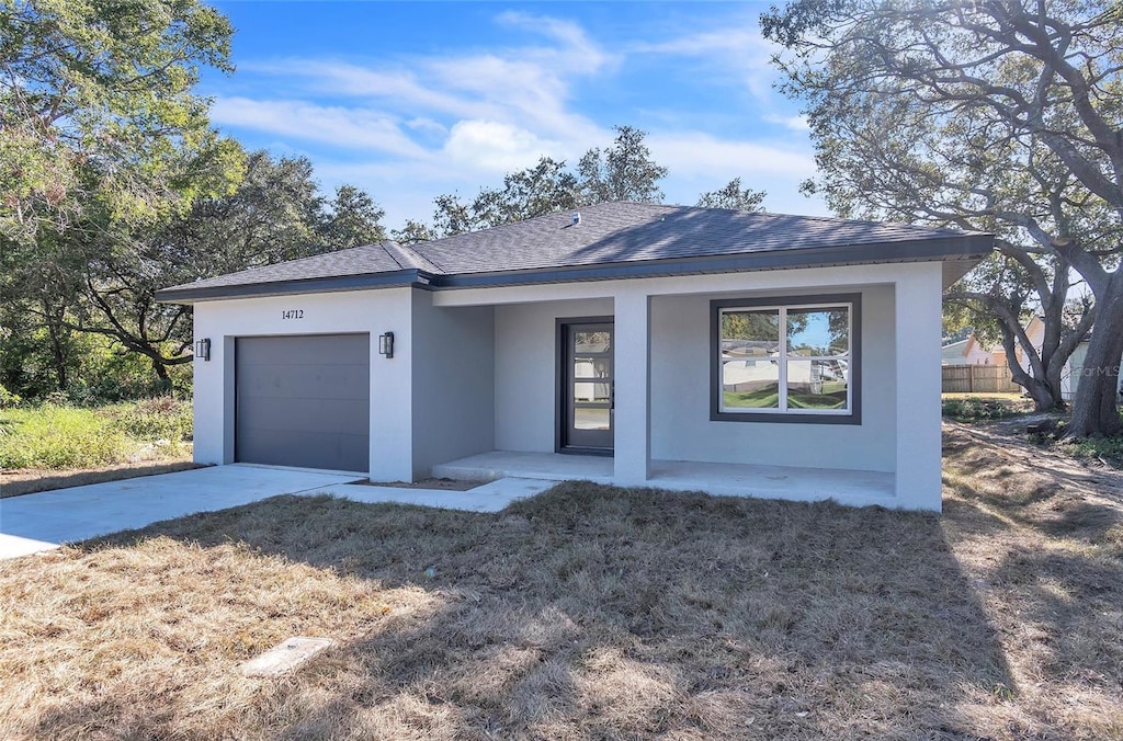 ranch-style home with covered porch and a garage