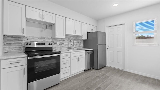 kitchen featuring sink, white cabinetry, and stainless steel appliances