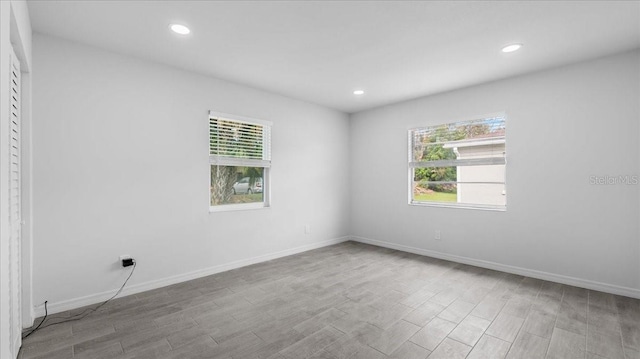 empty room featuring light hardwood / wood-style floors and a wealth of natural light