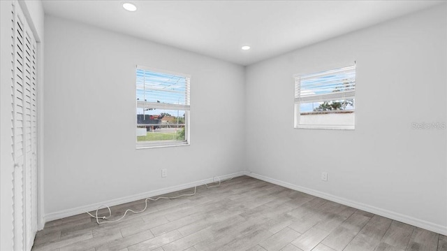 spare room with light hardwood / wood-style flooring