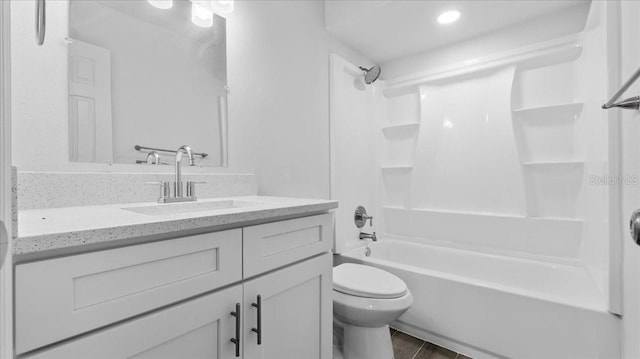 full bathroom with vanity, shower / bath combination, and toilet