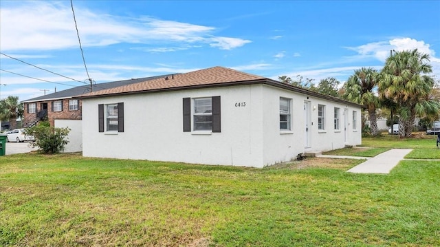 view of property exterior with a yard