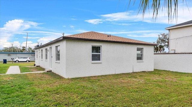 view of home's exterior with a lawn