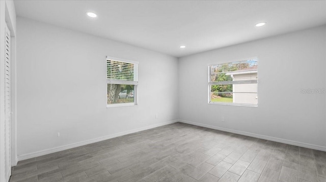 unfurnished room with plenty of natural light and wood-type flooring