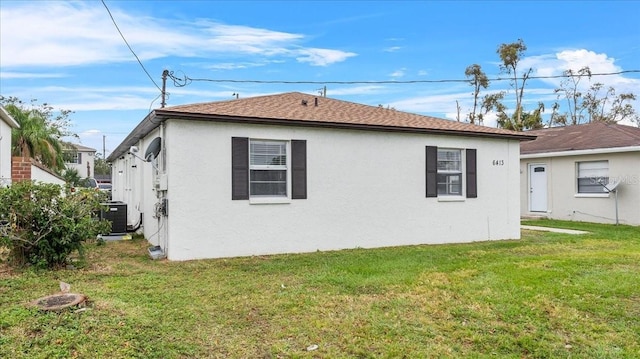 back of house with a lawn and cooling unit