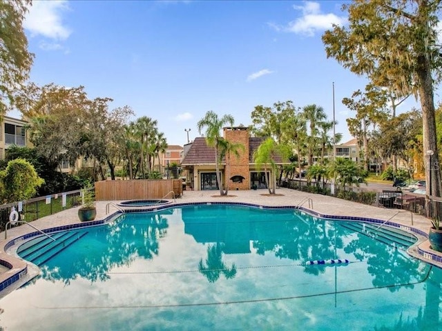 view of pool with a community hot tub