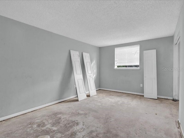 unfurnished bedroom with a textured ceiling