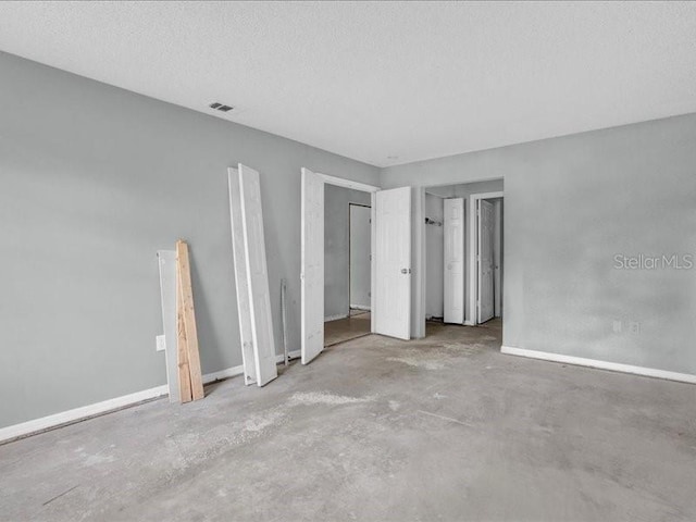 spare room with a textured ceiling