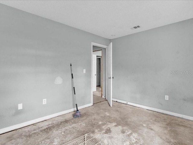 unfurnished room with a textured ceiling