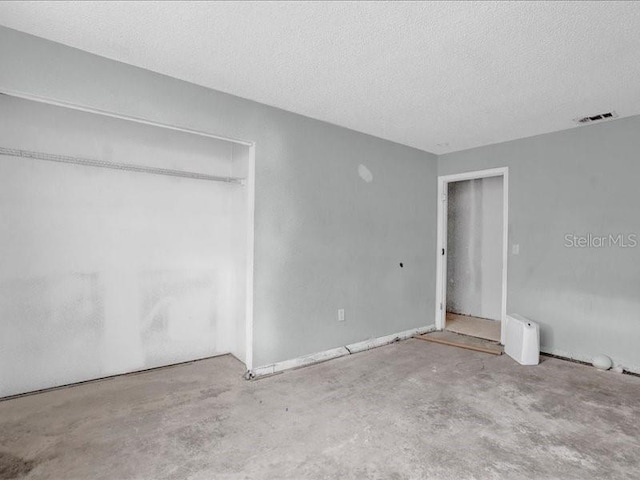 unfurnished bedroom featuring a closet and a textured ceiling