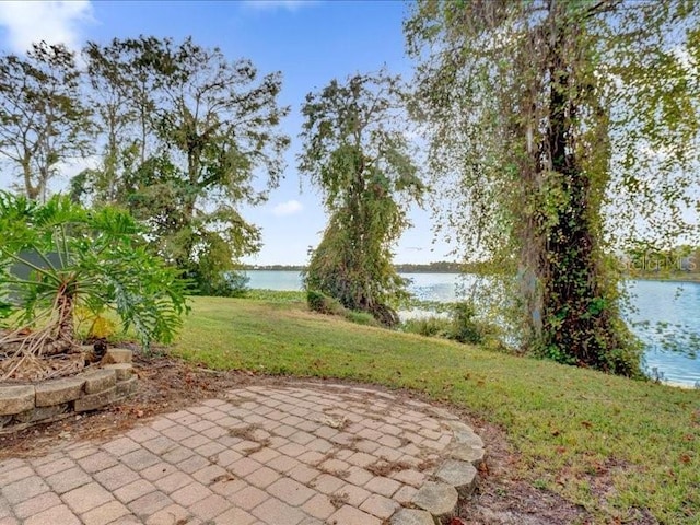 view of yard with a water view and a patio area