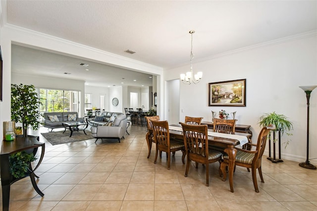 dining space with a chandelier, light tile patterned floors, and ornamental molding