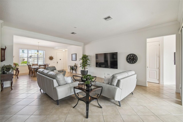 living room featuring a notable chandelier, ornamental molding, and light tile patterned floors