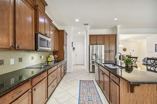 kitchen featuring a breakfast bar, sink, light tile patterned floors, tasteful backsplash, and stainless steel appliances