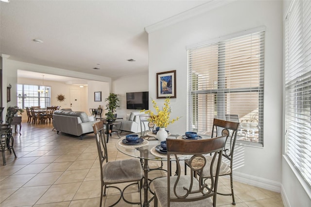 tiled dining room featuring ornamental molding