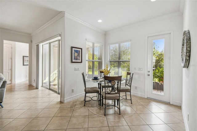 dining room featuring crown molding and light tile patterned flooring