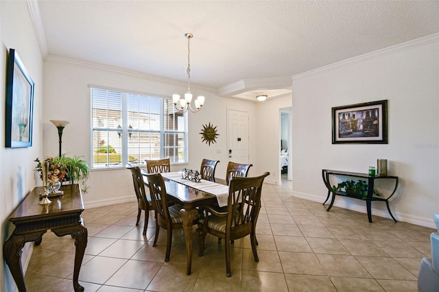 tiled dining room with crown molding, a textured ceiling, and an inviting chandelier