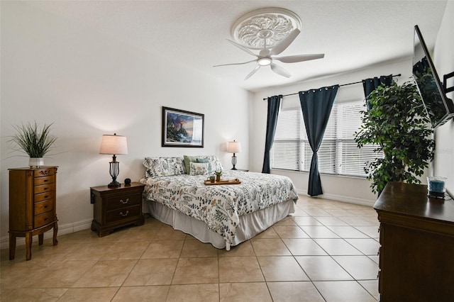 tiled bedroom featuring ceiling fan