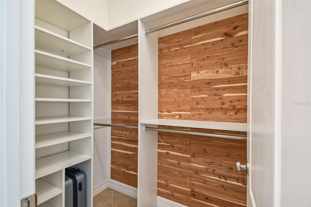 walk in closet with tile patterned floors