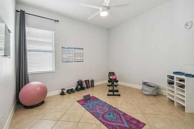 workout area featuring ceiling fan and light tile patterned floors