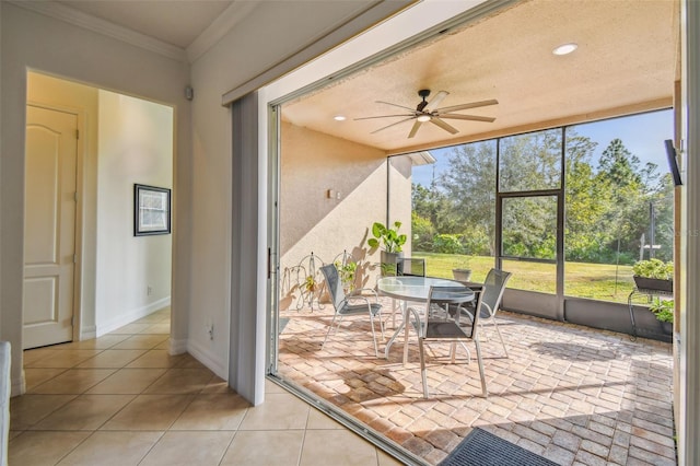 sunroom / solarium featuring ceiling fan