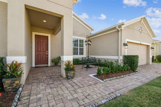 view of exterior entry featuring a garage