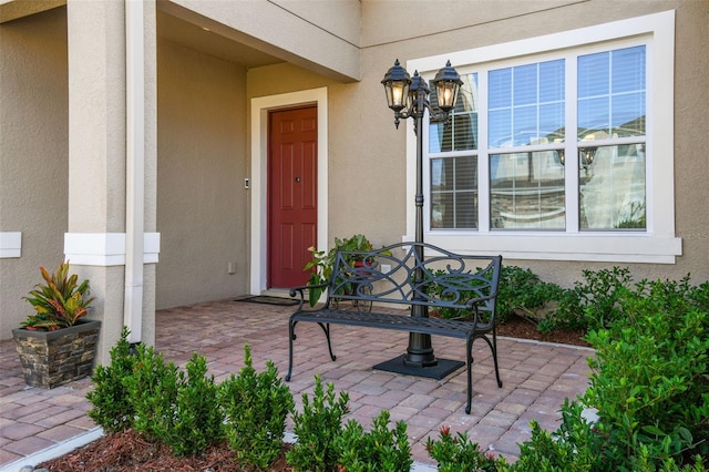 view of exterior entry featuring a patio area