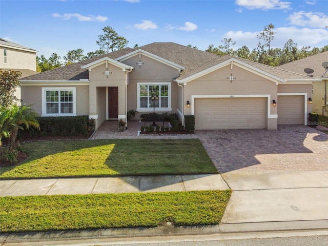 ranch-style home featuring a garage and a front yard