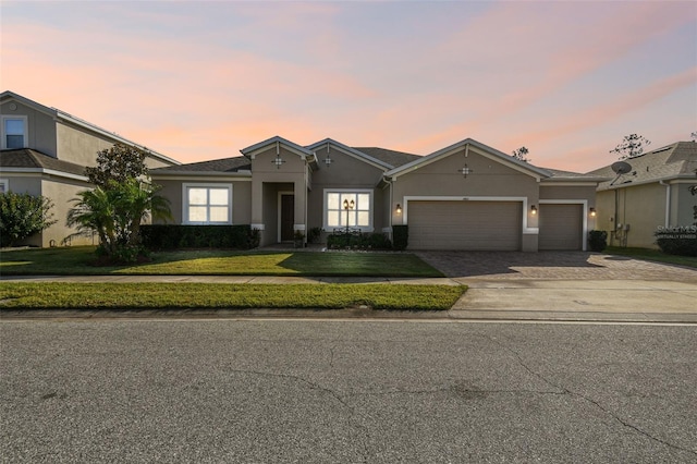 ranch-style house with a lawn and a garage