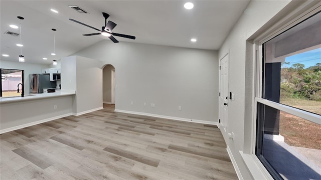 unfurnished living room featuring light hardwood / wood-style floors, ceiling fan, and lofted ceiling