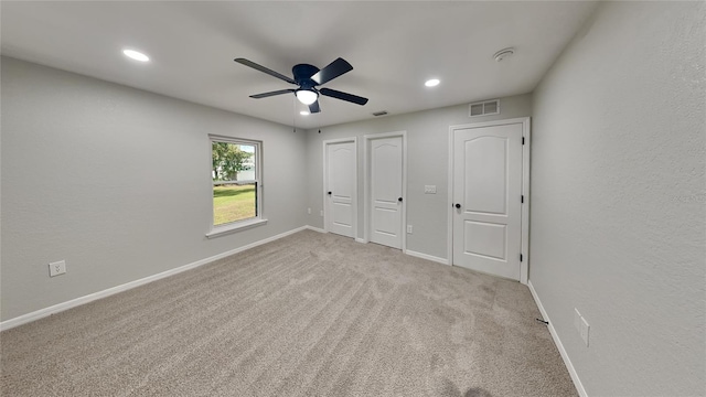 unfurnished bedroom with ceiling fan and light carpet