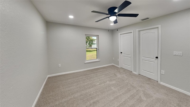 unfurnished bedroom featuring light carpet and ceiling fan