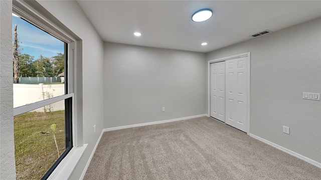 unfurnished bedroom with a closet and carpet floors