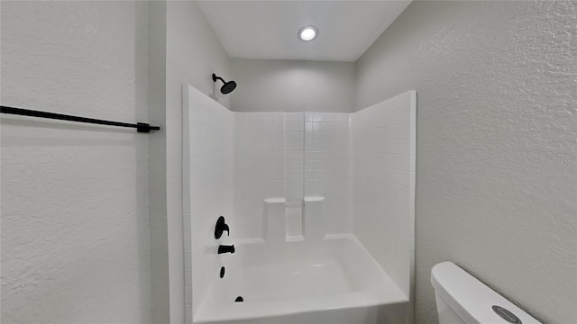 bathroom featuring toilet and shower / washtub combination