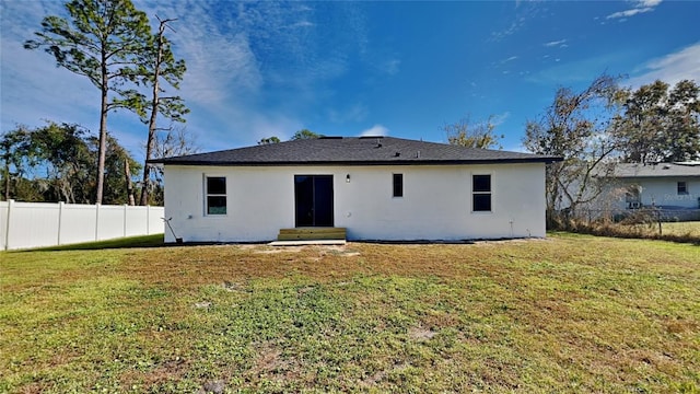 back of house with a yard