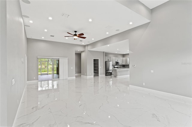 unfurnished living room featuring visible vents, baseboards, ceiling fan, marble finish floor, and recessed lighting