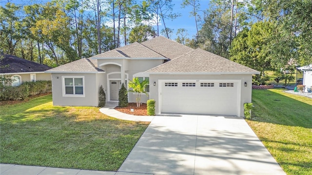 view of front of house featuring a garage and a front lawn