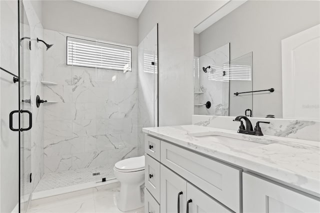 bathroom with vanity, toilet, and a shower with shower door