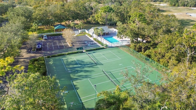 view of sport court featuring fence