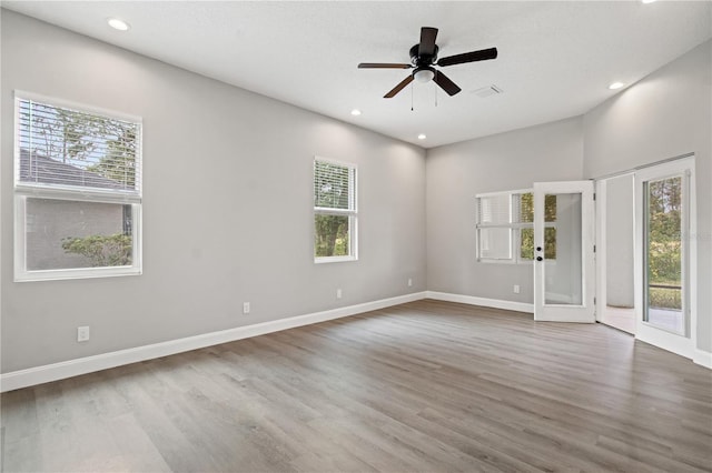 unfurnished room with recessed lighting, baseboards, and wood finished floors